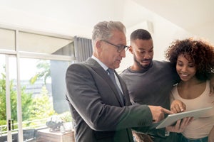 couple with agent in condo