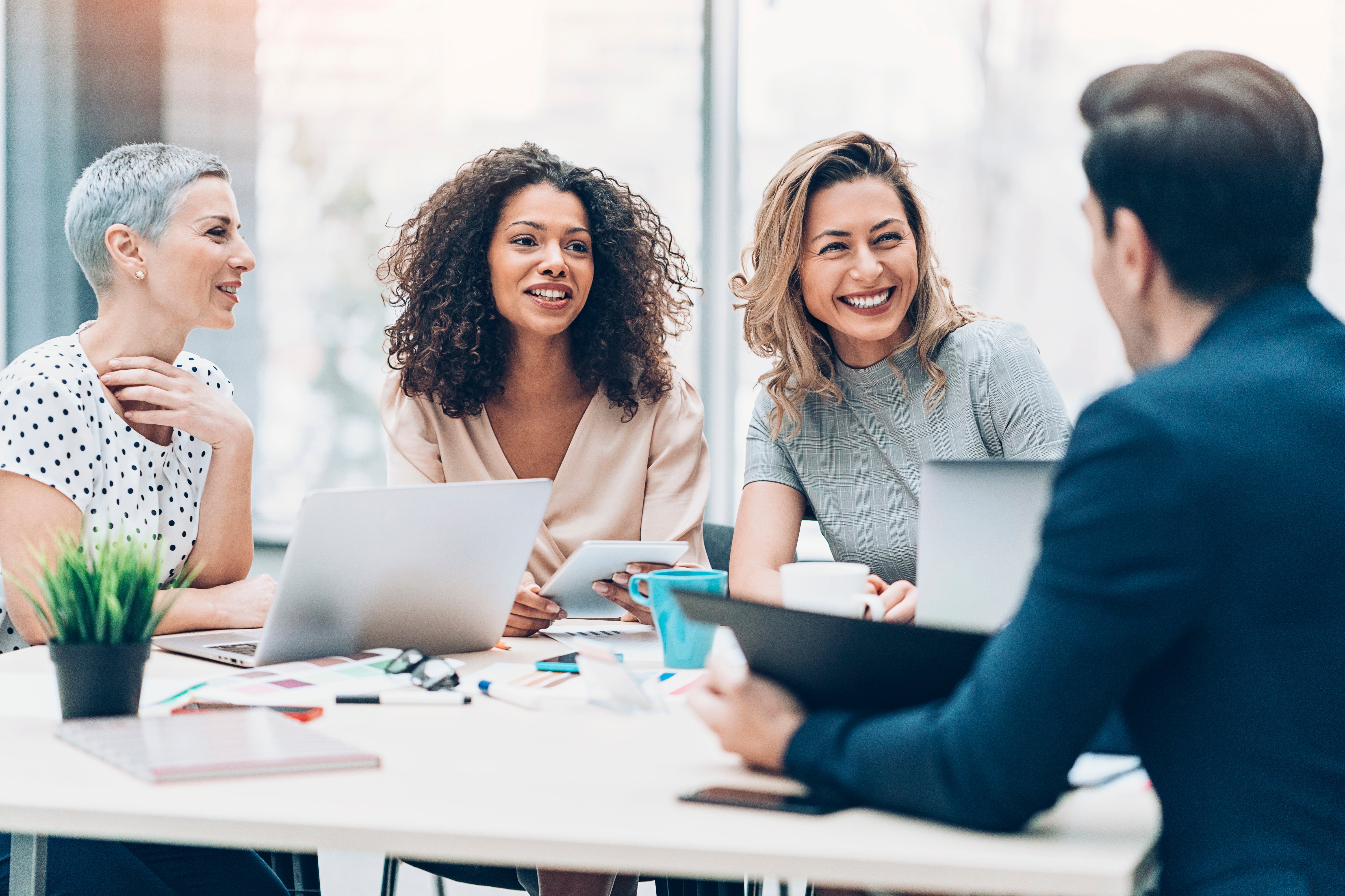 salespeople gathered around a conference table