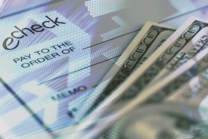 echeck and 100 dollar bills