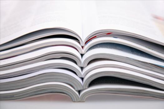several open notebooks piled on top of each other