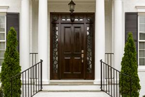 dark brown front door on elegant white house with columns