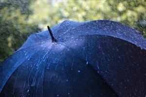 blue umbrella being rained on