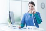 Medical professional takes a phone call at a nonprofit organization offering physicals.