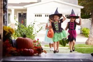 Trick or treaters safely entering a home.