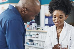 pharmacist showing prescription to customer