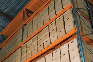 Inside of a warehouse with shelves containing multiple document size boxes