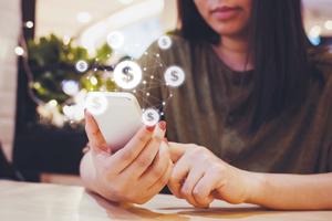 woman on mobile phone with dollar sign icons