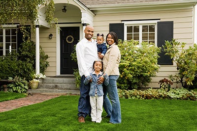 Couple standing in front of house