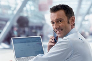 business professional on phone at computer