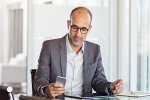 principle looking at phone in office