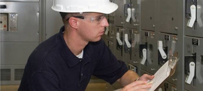 man inspecting electrical