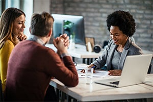 insurance agent gathered with customers at a table