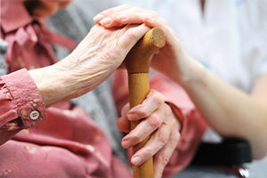 Elderly lady holding a cane