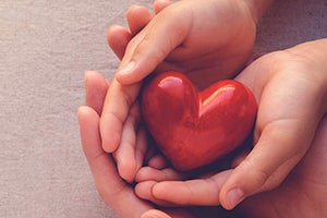 Hands holding a heart shape