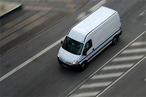 White van driving on the road