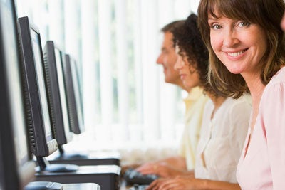 woman at a row of desktop computer screens
