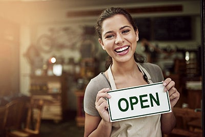 small business owner with open sign