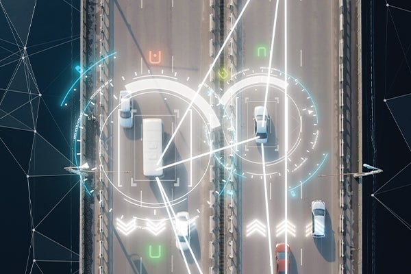 Aerial view of cars on a highway with computer generated imagery displaying telematics or GPS placement.