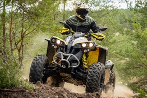 4-wheeler climbing a wooded mountain trail