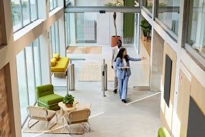 A person walking through a bright, open building interior
