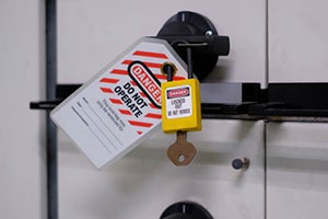 Lockout/tagout safety lock with “Danger – Do Not Operate” tag on industrial equipment.