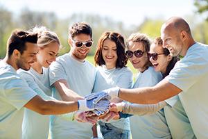 Group of volunteers stacking hands