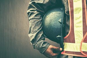 Worker holding helmet