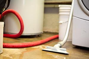 vacuum sucking up a water leak on a floor