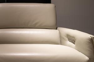 an image of an off-white colored leather couch with modern features in the arm