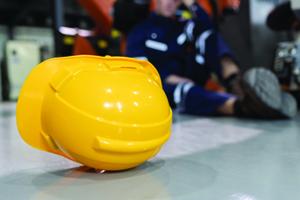 Yellow hard hat lying on a linoleum floor