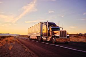Big rig driving on the open road in sunset