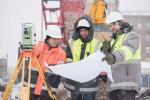 Three engineers working outdoors in winter