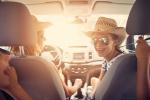 Smiling family in car on sunny day