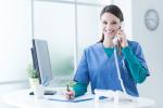 Medical professional takes a phone call at a nonprofit organization offering physicals.