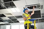 Facilities person inspecting HVAC system