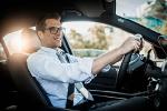 Close up photo of a businessman driving a car