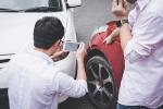 person taking digital photos at a car accident