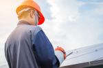 inspecting solar panels on roof