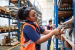 woman in warehouse taking inventory