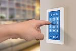 wall display showing house alarm security system with secret code number keypad with sensors and lock status. Hands pointing at touch display, digiting secret code number.