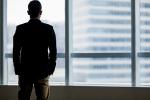 silhouette of man standing in window