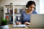 woman wearing headphones working at home