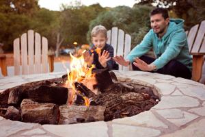 Man and child around a fire.