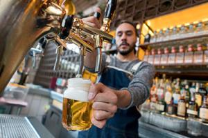 man serving beer