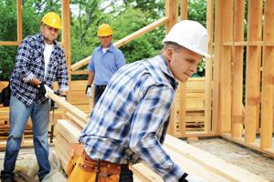 three contractors working on a house