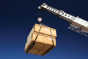 crane lifting crate into air