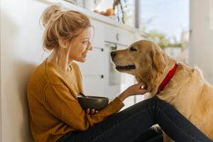 woman with dog in kitchen