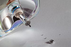 Broken lamp with mercury leaking out of it