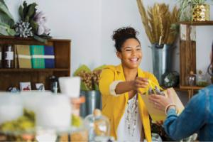 Young saleswoman helping customer