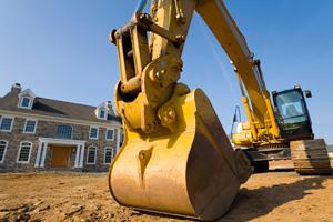 excavator parked in the front yard